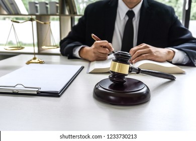 Law, lawyer attorney and justice concept, male lawyer or notary working on a documents and report of the important case in the workplace office.