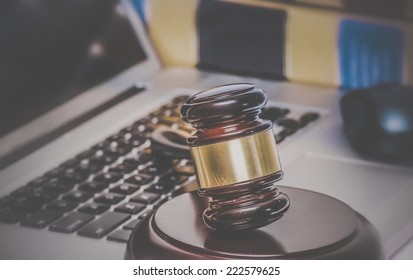 Law Legal Concept Photo Of Gavel On Computer With Legal Books In Background.