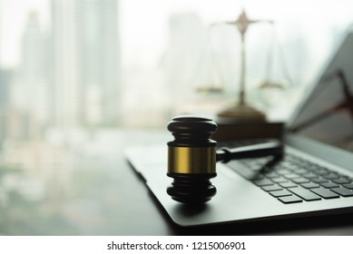 law legal technology concept. judge gavel and computer on desk of lawyer with legal icon.