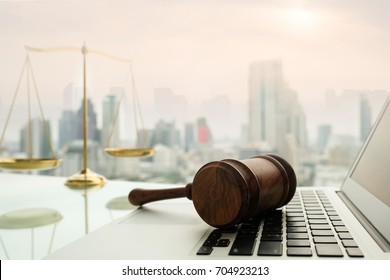 law legal technology concept.  judge gavel on computer with scales of justice on desk of lawyer. - Shutterstock ID 704923213