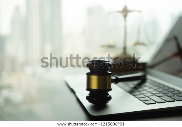 law legal technology concept.\
judge gavel and computer on desk of lawyer with legal\
icon.