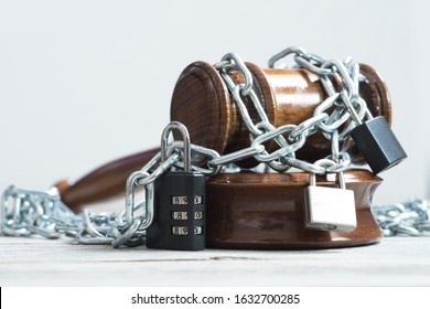 Law And Legislation Obstruction Concept With Judge Wooden Hammer Or Gavel Surrounded By Chains And Locks