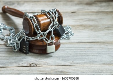 Law And Legislation Obstruction Concept With Judge Wooden Hammer Or Gavel Surrounded By Chains And Locks