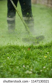 Law Mower Man Trimming Grass In The City