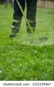 Law Mower Man Trimming Grass In The City