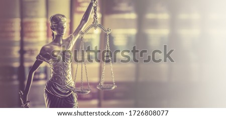 Law office banner concept image, Scales of Justice with legal books in background.  