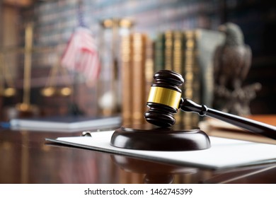 Law symbols in composition. Judge's gavel on wooden table. Library background. - Shutterstock ID 1462745399