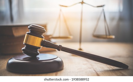 Law theme, mallet of the judge, law enforcement officers, evidence-based cases and documents taken into account.	 - Shutterstock ID 1938588952