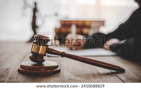 Law theme, mallet of the judge, law enforcement officers, evidence-based cases and documents taken into account.	

