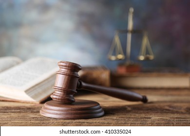 law theme, mallet of the judge, justice scale, hourglass, books, wooden desk