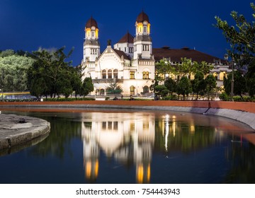 Lawang Sewu building, an old Dutch colonial building, reflects at night in a fountain in Semarang city on Java island in Indonesia