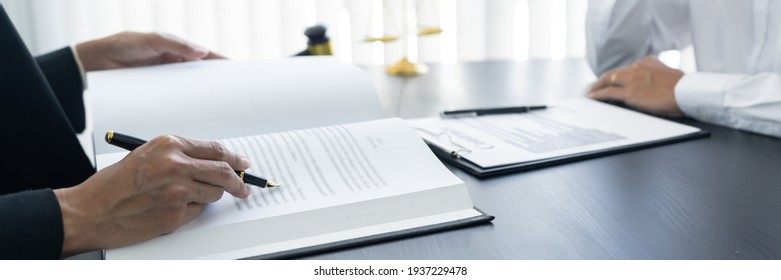 law,libra scale and hammer on the table, 2 lawyers are discussing about contract paper, law matters determination. - Shutterstock ID 1937229478