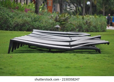 Lawn Chairs Sitting In A Row On The Grass