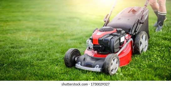 Lawn mover on green grass in modern garden. Machine for cutting lawns. - Shutterstock ID 1730029327