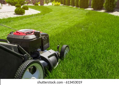 Lawn mower on green grass  - Shutterstock ID 613453019