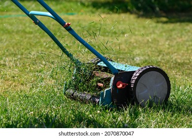 lawn mowing with a manual drum lawn mower - Shutterstock ID 2070870047