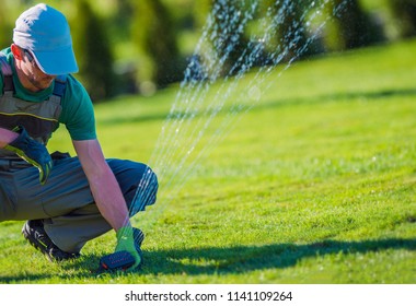 Lawn Sprinkler Installation By Professional Technician. Gardening And Landscaping Theme.