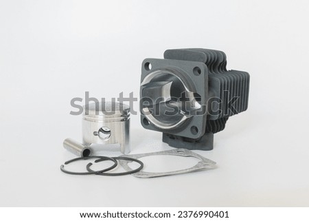 The lawnmower cylinder and engine block are spare parts on white background