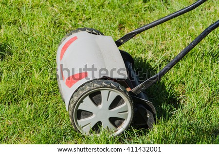 lawnmower on green grass in garden
