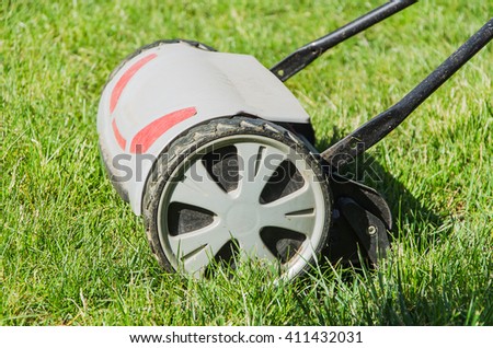 lawnmower on green grass in garden