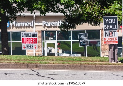 LAWRENCEVILLE, GAUSA -  OCTOBER 9 2021:  A Person Holds A Pro Life Sign Outside A Planned Parenthood Clinic On October 9, 2021 In Lawrenceville, GA.