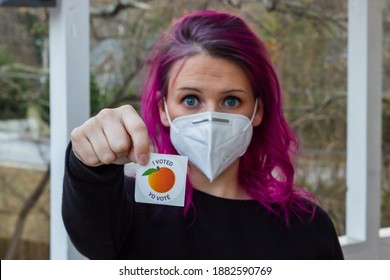 Lawrenceville, Georgia | United States - December 26 2020: A Georgia Voter Wearing A Mask Holds Up Her 