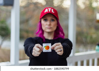 Lawrenceville, Georgia | United States - December 26 2020: A Georgia Voter Holds Up Her 