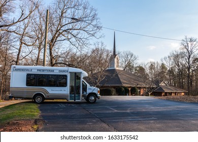 Lawrenceville,GA / USA January 30 2020: Entry driveway of  Lawrenceville Presbyterian Church, with the church in the background, and a church bus in the foreground parking lot
