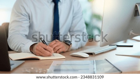 Lawyer and attorney working on corporate plans and compiling legal reports for a case at his desk. Business man and project manager writing notes on paper while working on a computer in an office