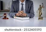 Lawyer business man holding document to reading lawsuit and checking about financial business data while analysis about legislation agreement and terms data of business contract in law firm.
