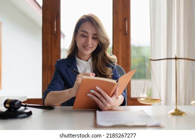 Lawyer business woman reading law book and agreement contract. - Powered by Shutterstock