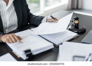 Lawyer businessman working with lawbook in office or courtroom Legal counsel with gavel and legal law. justice and lawyer concept Judge gavel hammer on Lawyer desk