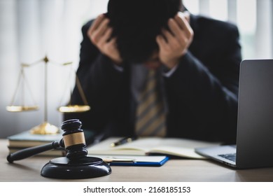 A lawyer or businessman is stressed about losing a lawsuit and going bankrupt.