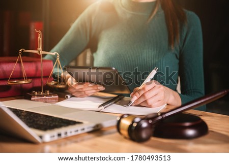 Lawyer businessman and two business partners working together in office. Businessmen sitting at desk and making notes.