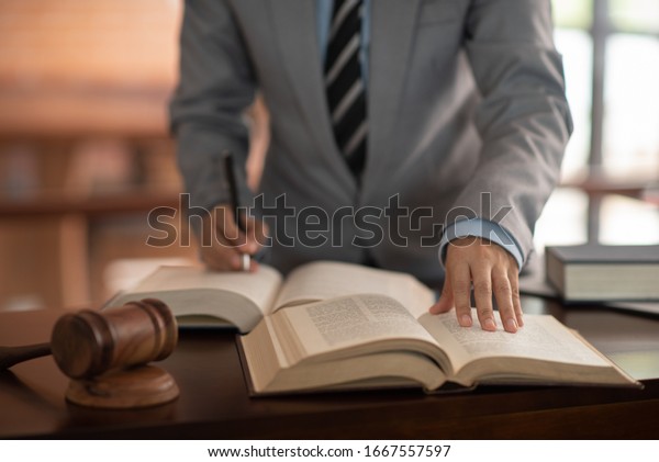 lawyer businessman working and study\
legal regulations at lawer\'s office. law legal\
concept.