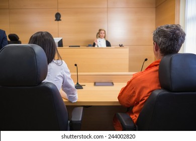 Lawyer And Client Listening To Judge In The Court Room