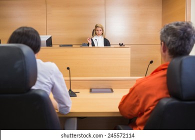 Lawyer And Client Listening To Judge In The Court Room