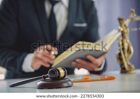 The lawyer considers with contract documents and laptops in the trial room. Justice, law, lawyer and judicial judge