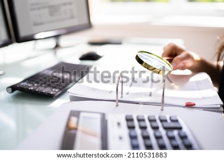 Lawyer Examining Paper Using Magnifier Glass. Tax Fraud Investigation