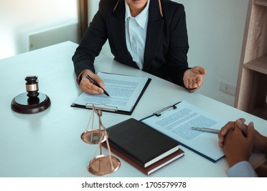 Lawyer is explaining about the wrongdoing laws regarding fraud to the client at the office.