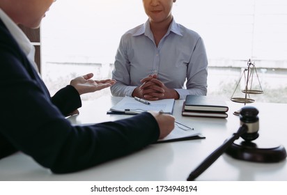 Lawyer is explaining about the wrongdoing laws regarding fraud to the client at the office.