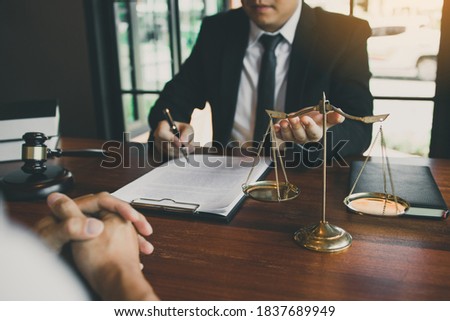 Lawyer is explaining about the wrongdoing laws regarding fraud to the client at the office.