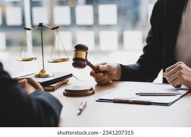 Lawyer is explaining the terms of the legal contract document and asking the client to sign it properly. Legal counsel and legal proceedings consulting services.