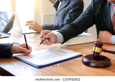 Lawyer give his customers signed a contract in the document. Consulting in regard to the various contracts - Shutterstock ID 1155932422