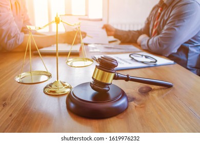 The Lawyer Is Giving Legal Advice To Investors And Discussing Legal Contract Documents To Be Used As A Contract Between Investors Signing A Consent To Invest In Doing Business Together.