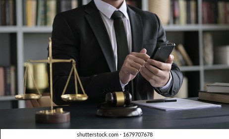 Lawyer Hand USing Smartphone In Court Room