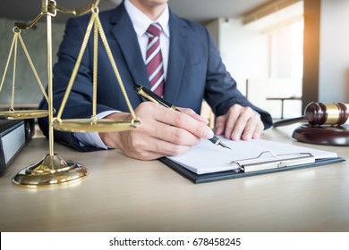 lawyer hand writes the document in court (justice, law).