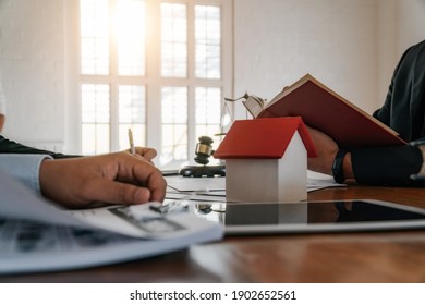 Lawyer Hands Hold Real Estate Law Book And Clarify Real Estate Law To Client Before Signing Contract Document