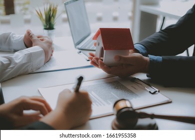 lawyer insurance broker consulting giving legal advice to couple customer about buying renting house. financial advisor with mortgage loan investment contract. realtor selling real estate property - Shutterstock ID 1661955358