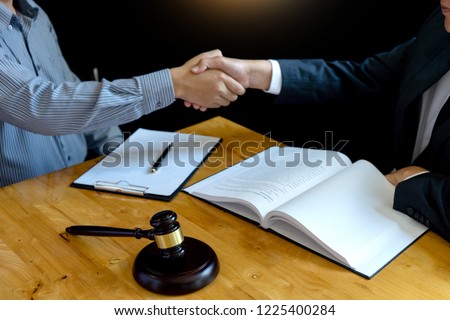Lawyer or judge gavel with balance handshake with client or customer about agreement how to  use arbitration